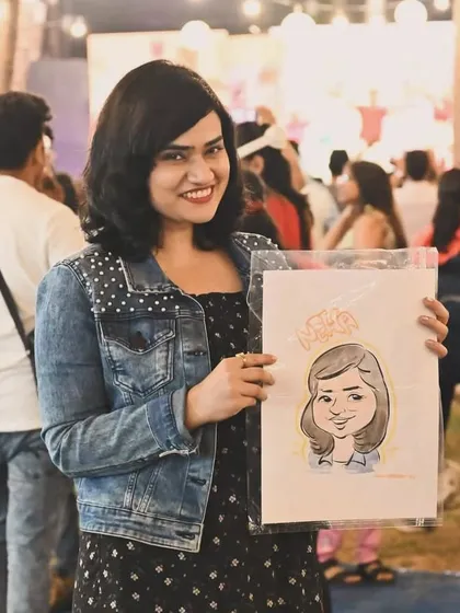 A happy guest at an outdoor festival with her colored caricature.