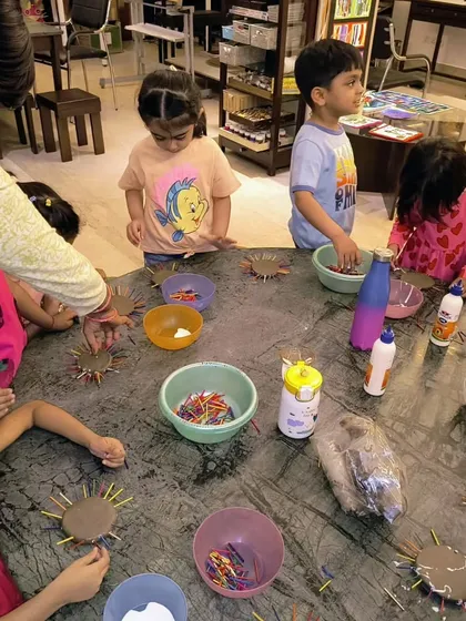 A table full of toddlers engaged in our funky summer clay project. Each child gets their own materials to explore and create at their own pace.