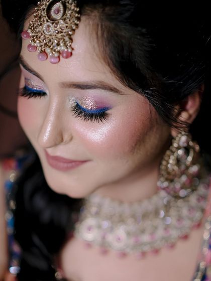 A close-up shot of the bride's stunning eye makeup and jewelry.