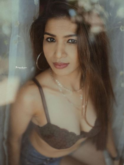 A powerful and direct look captured through a window. This image combines intimacy with confidence, a hallmark of my portrait style.