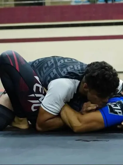 "Rome wasn't built in one day." A close-up shot of one of our fighters competing in a grappling match, showcasing the intensity and focus required.