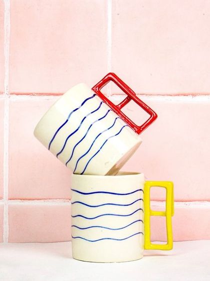 Two of the modern mugs stacked on top of each other. This playful composition highlights their unique design and is great for social media.