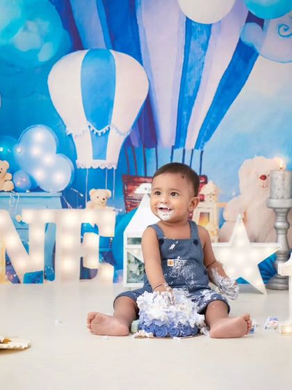 A full view of the cake smash aftermath. The joy on his face is priceless, surrounded by the fun and messy evidence of his first birthday treat.