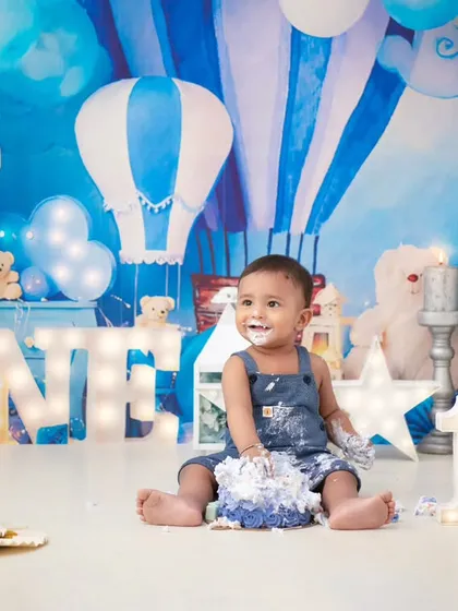 A full view of the cake smash aftermath. The joy on his face is priceless, surrounded by the fun and messy evidence of his first birthday treat.