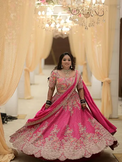 The full glory of this pink embroidered lehenga is on display as our client twirls. The volume of the skirt and the intricate work on the hem are simply breathtaking.