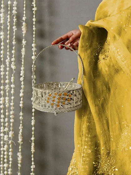 From decorating your home to gifting to loved ones, our enamel peacock basket is the perfect blend of utility and festive elegance. Here, it is held to showcase its delicate scale and beautiful design.