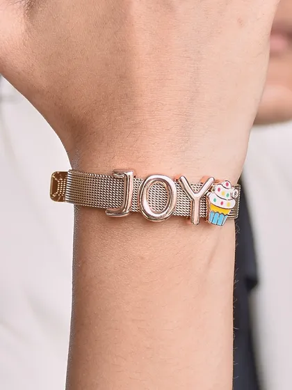 Spell it out. This custom watchbelt bracelet spells out 'JOY' and features a cute cupcake charm. It's the perfect way to wear your personality on your wrist.