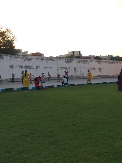 A wider perspective of the academy grounds, with a skating class happening on the court next to our green lawn.