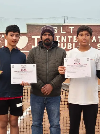 Anay Pandey stands with his coach and doubles partner after a triple-win performance at the CS7 Tournament in Sonipat. He secured titles in U-14 Singles, U-16 Singles, and U-16 Doubles, showing incredible versatility.