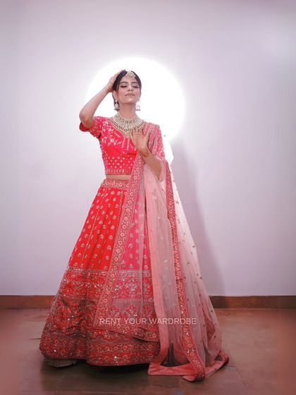 A full-length view of the two-tone pink lehenga, showing its beautiful flare. This is a great option for creating dynamic and graceful bridal portraits.