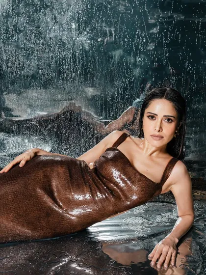 A reclining pose from the same set, creating an elegant and serene mood amidst the dynamic water effects.