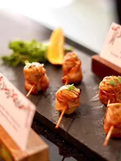 An elegant canapé of London-style sausages wrapped in bacon, a favorite at our Christmas brunch. These savory bites are perfect for passing around at festive gatherings and holiday parties.