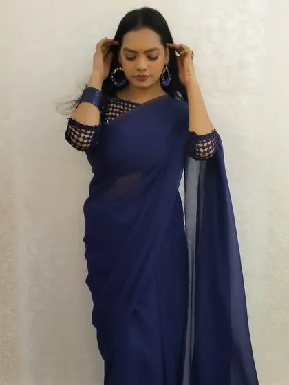 A graceful and poised shot, the deep blue of the saree making a bold statement.