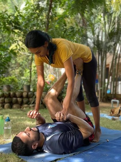 A student and I work on the fundamentals of acro-yoga, demonstrating the trust and partnership we build in these sessions.