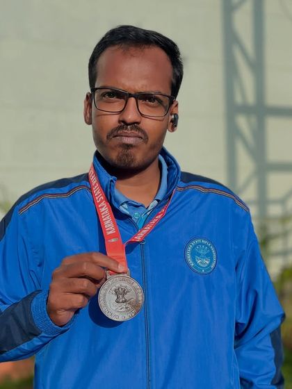 One of our national Air Pistol shooters proudly displaying his medal after a successful competition.