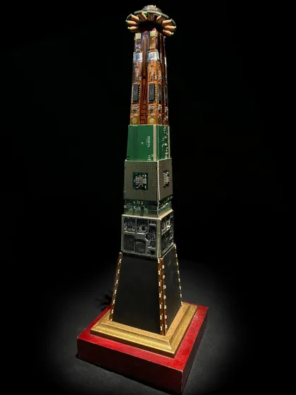This custom award is designed to look like a skyscraper, built from stacked circuit boards and processors on a red wooden base. It's an elegant eco-design that makes a statement about innovation and sustainability.