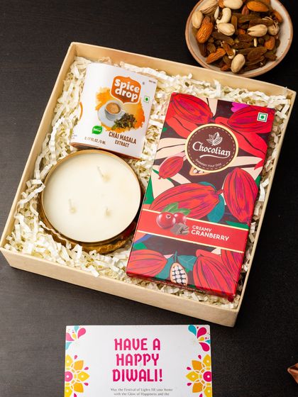 Simple, elegant, and comforting. This gift box includes a large three-wick candle, a packet of chai masala, and a bar of creamy cranberry chocolate, perfect for a cozy Diwali evening.