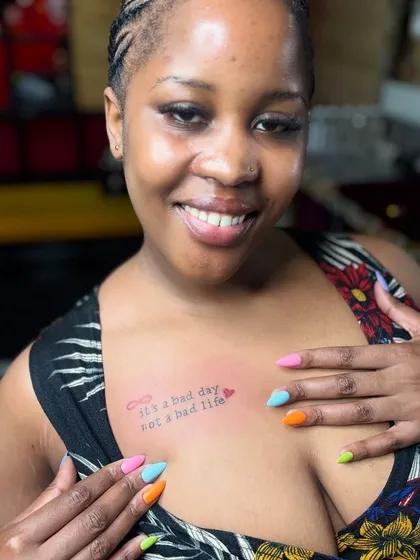 A happy client from Uganda showing off her new tattoo and manicure. We love welcoming people from all over the world to our studio.