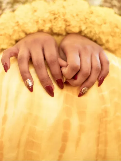 A close-up on the bride's hands, showcasing her beautiful manicure, a small but important detail.