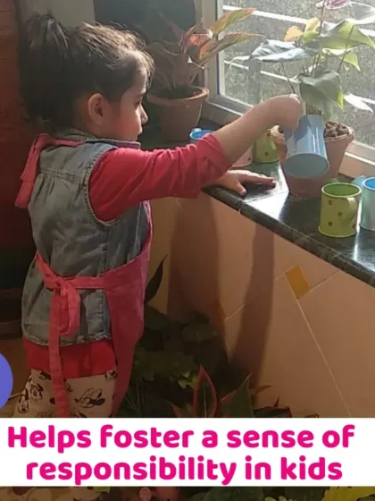 A little girl carefully watering the plants. This simple task helps foster a sense of responsibility and care for living things.