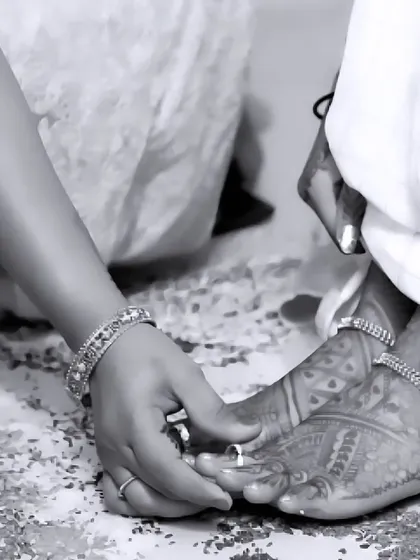A beautiful black and white shot focusing on the details of a wedding ritual. This image highlights the bride's henna-adorned feet and the traditional toe rings, symbolizing a new beginning.