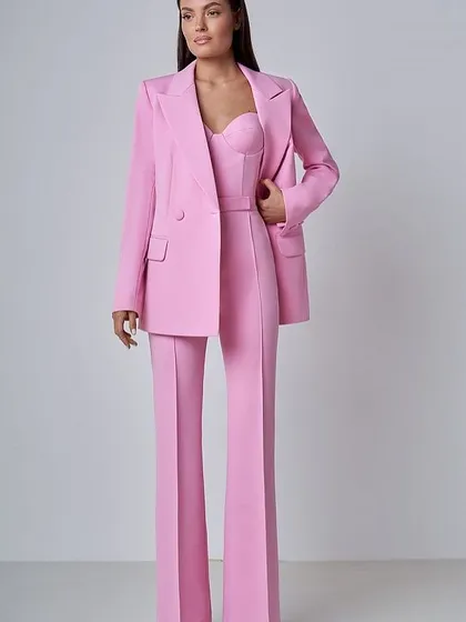 This vibrant pink power suit is a real showstopper. It features a double-breasted blazer, wide-leg trousers, and a matching corset top for a modern twist on formal wear.