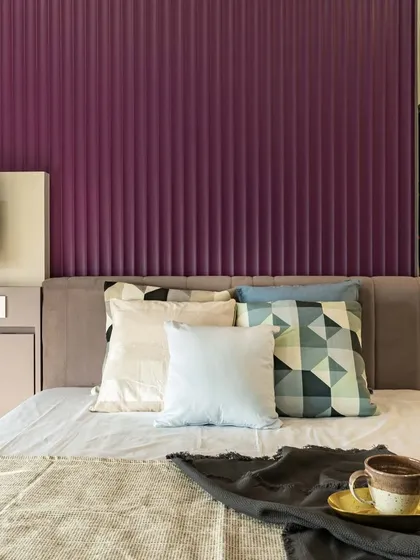 A view of the bed and TV unit in the master bedroom. The design ensures that every element is cohesive, from the color palette to the textures used throughout the room.