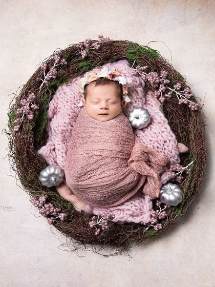 Wrapped in love and sprinkled with dreams. This rustic, nest-like prop with soft pink tones creates a cozy and natural-looking portrait.