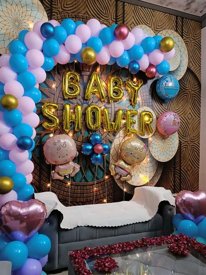 The vibrant colors of the blue and pink balloons create a classic and joyful look for a baby shower. The gold accent balloons add a touch of elegance to the arrangement.