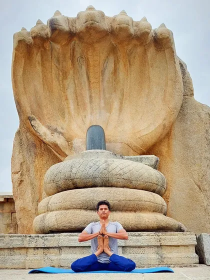 In a posture of reverence before a sacred Shiva Lingam, I connect with the origins of yoga. My workshops are steeped in this ancient tradition, viewing yoga not just as exercise, but as a profound spiritual discipline or 'sadhana' for harmonizing body, mind, and spirit.