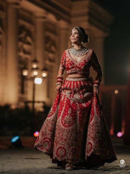 A full-length shot showcasing the entire bridal ensemble. The makeup, hair, and outfit all come together to create a cohesive and breathtaking look.