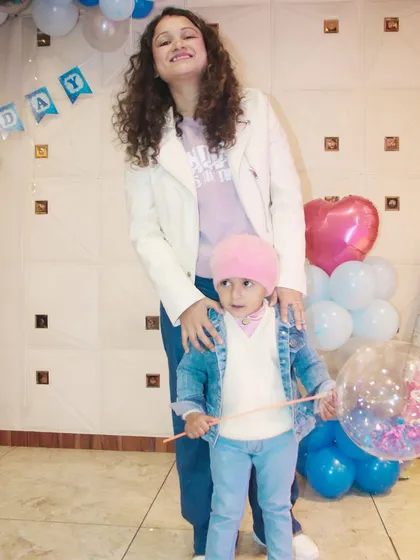 A mother and child posing for a photo at a party. I capture both casual and formal portraits throughout the event.