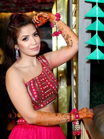 A stylish portrait of the bride-to-be at her Mehndi party, showing off her modern outfit and beautiful henna.