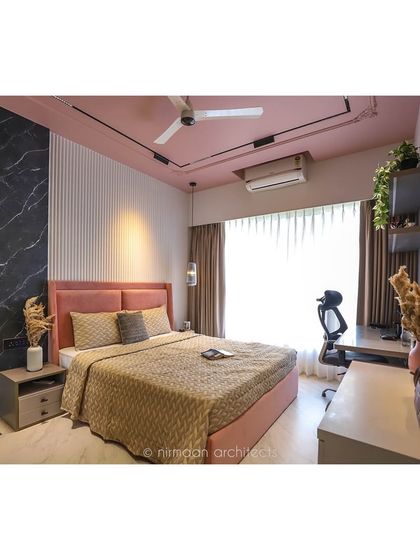 The 'Atmosphere' master bedroom is a blend of textures and colors, with a pink ceiling, a black marble wall, and a comfortable study corner. It's a space that is both productive and peaceful.