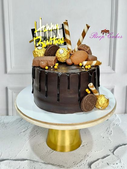 The ultimate chocolate experience. This drip cake is loaded with Ferrero Rocher, Oreo cookies, and chocolate bars.