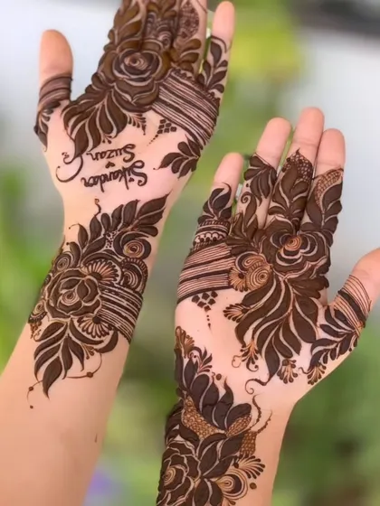 A Dubai-style floral design with the couple's names hidden in the leaves. It's a modern way to personalize your mehendi.