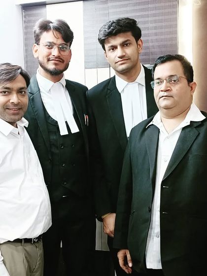 Posing with senior members and colleagues at the law office.