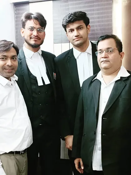Posing with senior members and colleagues at the law office.