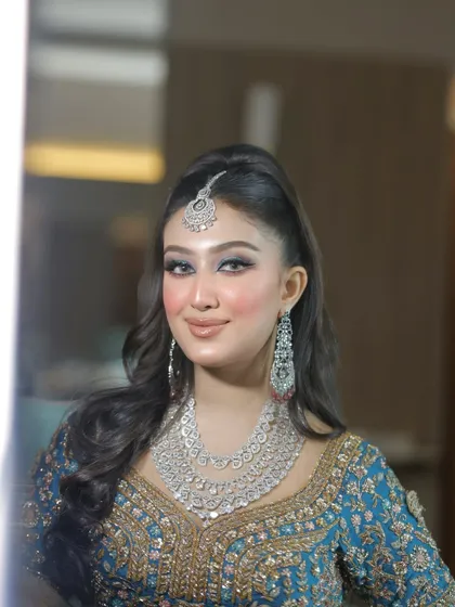 A beautiful portrait showing off the flawless makeup and high-ponytail hairstyle.