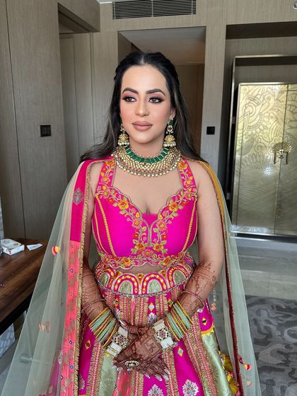 The bride looking beautiful and confident, her unique hairstyle adding a touch of magic to her vibrant outfit.