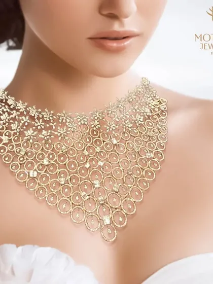 An image of a spectacular, wide diamond bib necklace, a masterpiece of intricate design and breathtaking sparkle.