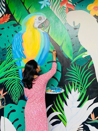 This vibrant tropical mural featuring two large macaw parrots was a joy to create. The bold colors and dense foliage on a black background make for a dramatic and stunning photo point in a restaurant.