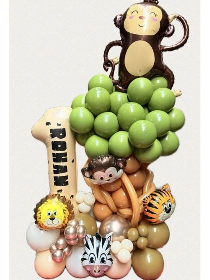 A clear shot of the custom jungle-themed balloon standee for Rohan's first birthday. The vibrant green balloons and cute animal characters make it a perfect centerpiece or photo prop.