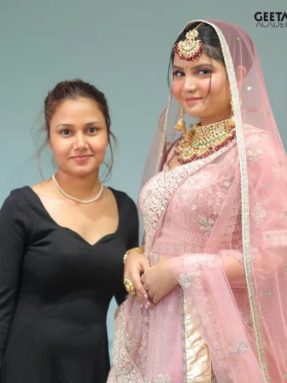 Student Work: A proud student stands with her model, showcasing a beautiful pink-themed bridal look. This is the result of dedicated learning and hands-on practice.