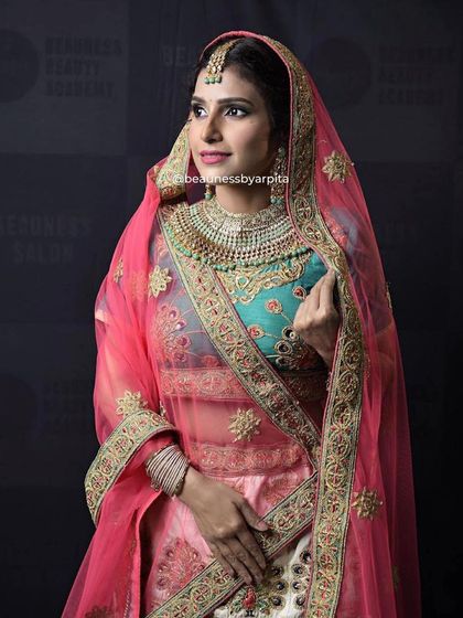 A beautiful multi-colored lehenga with a pink dupatta. This outfit is perfect for guests who want to stand out at a wedding.
