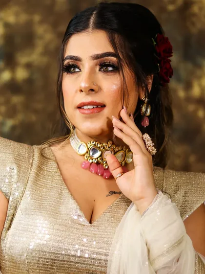 A beautiful hair and makeup transformation. This look features a dramatic golden glitter cut-crease, bold brows, and a romantic hairstyle with red roses.