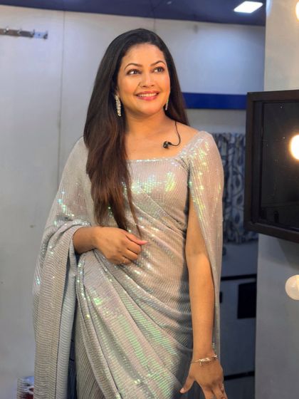 A backstage shot of Priyanka Barve, showing the unique cape-style sleeves of her sequin saree.