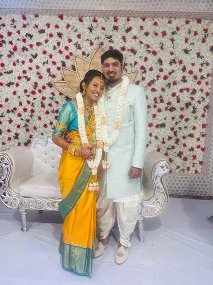 Here is our lovely client Geeta with her husband, creating a beautiful memory on their special day. She is draped in a vibrant yellow Kanchipuram silk saree, a perfect choice for a wedding ceremony that radiates happiness and tradition.