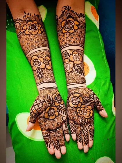Another angle of the stunning rose-themed mehandi, showing the pattern extending up the arm.