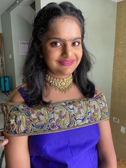 Joshitha at her housewarming ceremony. For this youthful look, I used a pop of bright pink on the lips and soft, shimmery eyeshadow.